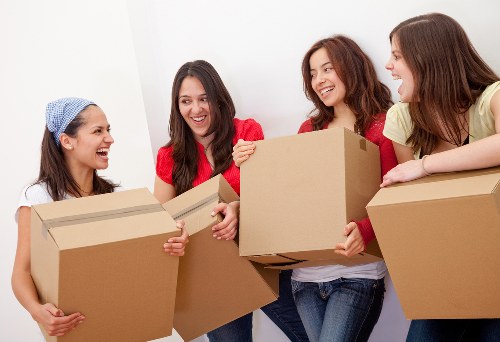 Movers carrying furniture through a home during an Oakleigh Park relocation