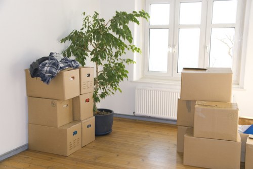 Residential moving team handling boxes and furniture in Oakleigh Park