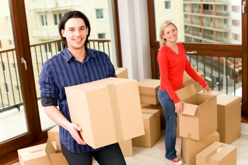 Local moving team packing household items for transport